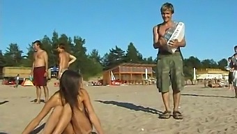 A Young And Stunning Teen Disrobes And Frolics In The Public Beach